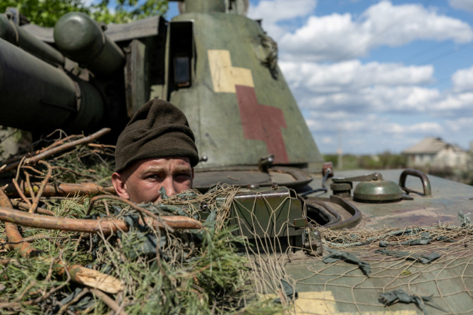 Seorang tentara Ukraina melihat keluar dari sebuah tank, di tengah invasi Rusia ke Ukraina, di kota garis depan Lyman, wilayah Donetsk