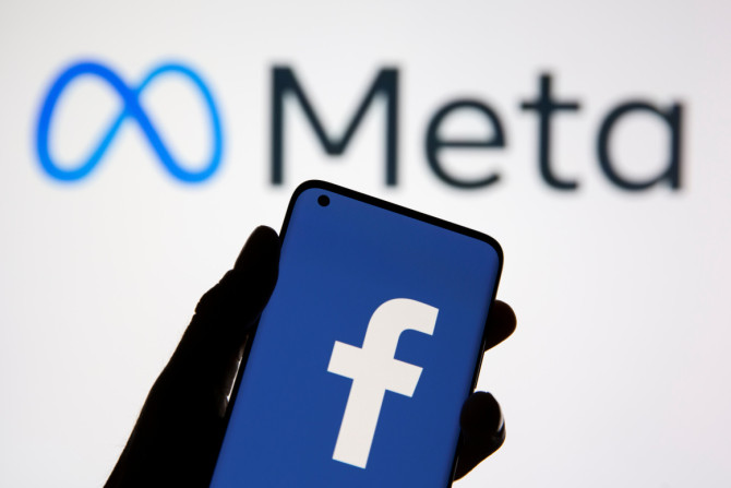 Sebuah smartphone dengan logo Facebook terlihat di depan logo baru Facebook yang ditampilkan Meta dalam ilustrasi ini