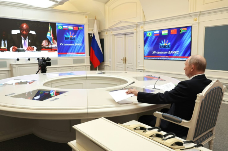 Putin, terlihat di sini dalam gambar yang didistribusikan oleh kantor berita Rusia Sputnik, bergabung dalam pertemuan puncak tersebut melalui tautan video